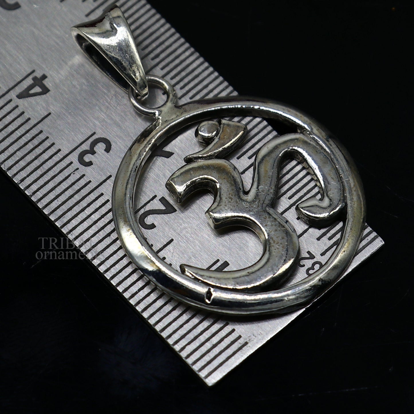 Sterling silver Hindu mantra Aum OM pendant by TRIBAL ORNAMENTS, featuring intricate tribal design and personalized good luck symbolism.