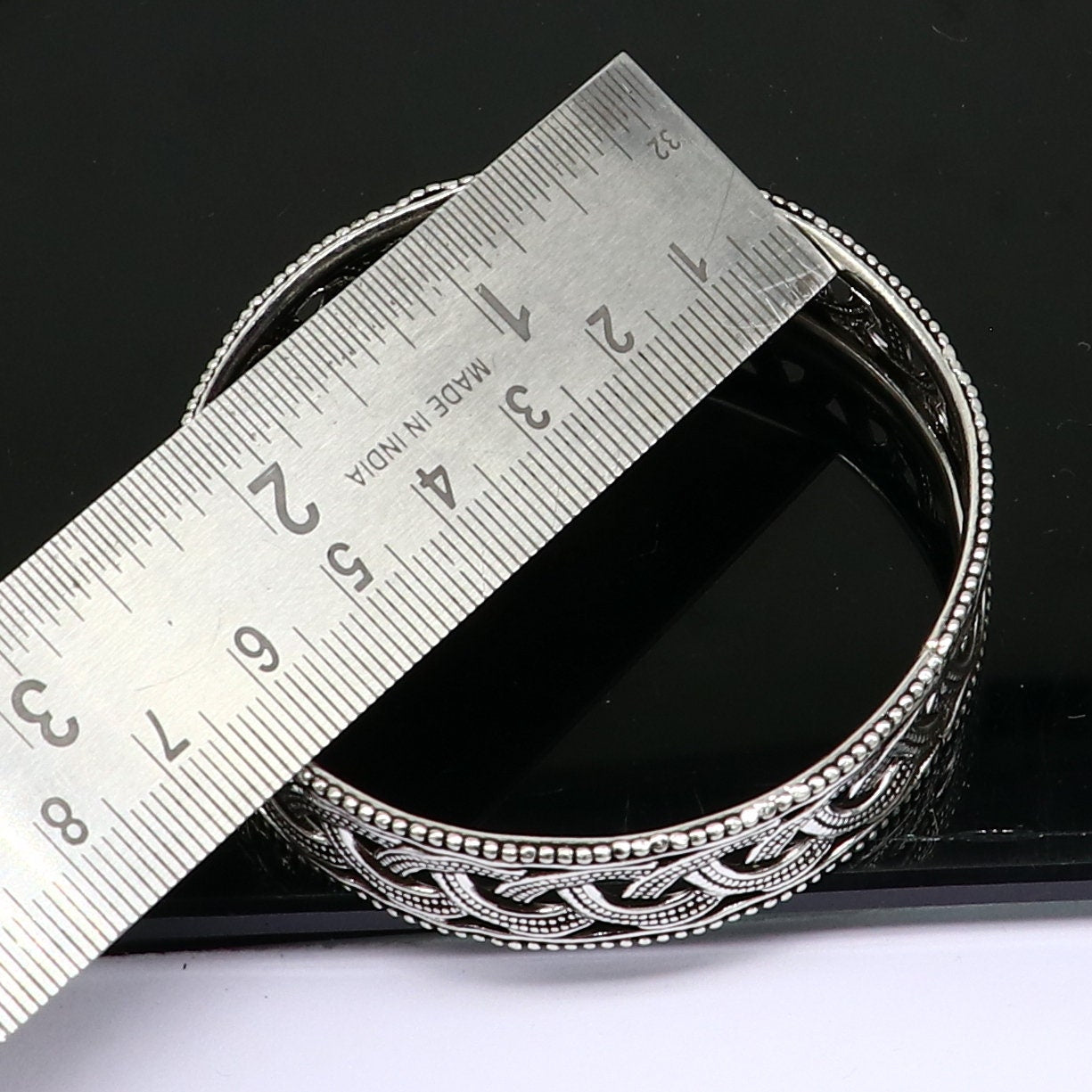 Sterling silver floral bangle bracelet by TRIBAL ORNAMENTS, featuring intricate tribal design, perfect for brides and special occasions.