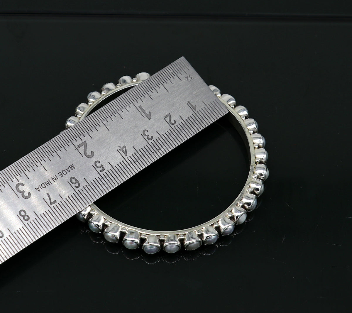 Sterling silver pearl bangle bracelet by TRIBALORNAMENT featuring oxidized finish, perfect for brides or elegant jewelry gifting.
