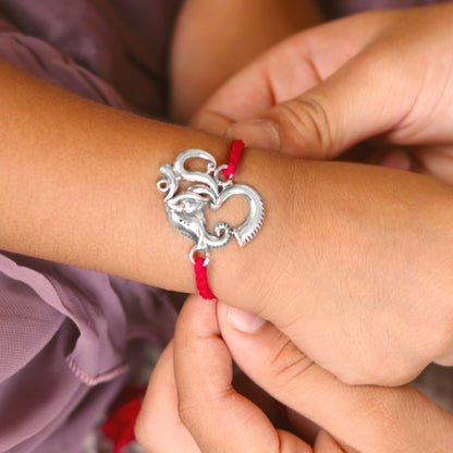 Sterling silver Ganesha Om thread bracelet by TRIBAL ORNAMENTS with intricate design, suitable for traditional occasions.