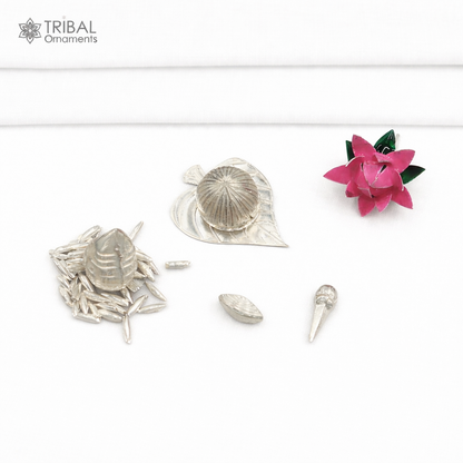 925 sterling silver Pooja accessories including Supari, Paan leaves, rice, cloves, coconut, cardamom, and flowers for worship.