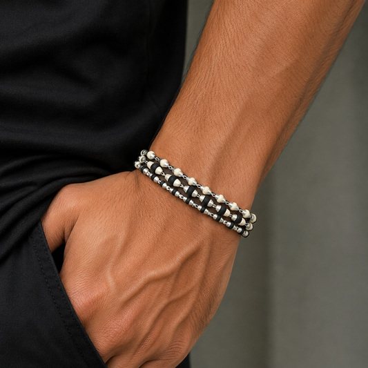 Handmade sterling silver three-line bracelet with black and white tulsi plant wood beads, intricate design by TRIBAL ORNAMENTS.