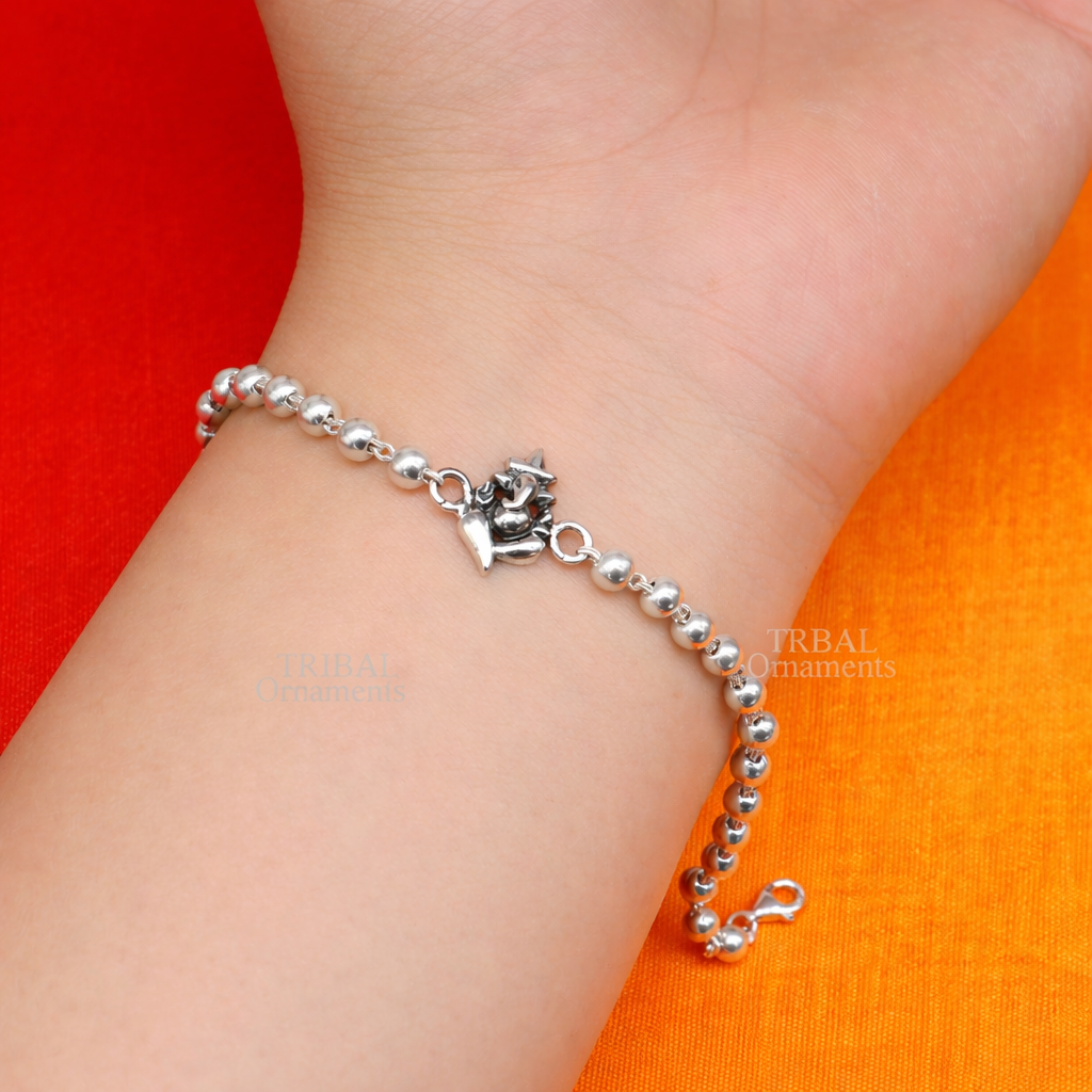 Sterling silver Lord Ganesha bracelet with Rudraksha and Tulsi beads, handcrafted by TRIBAL ORNAMENTS.