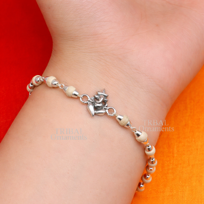 Sterling silver Lord Ganesha design bracelet with Rudraksha and Tulsi beads, handcrafted by TRIBAL ORNAMENTS.