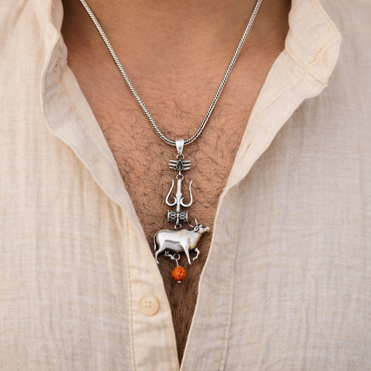 Silver Shiva trident pendant with damru and Nandi design, showcasing intricate craftsmanship from Tribal Ornaments.