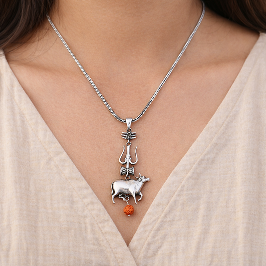 Silver Shiva trident pendant with damru and Nandi design from TRIBAL ORNAMENTS, featuring intricate craftsmanship.