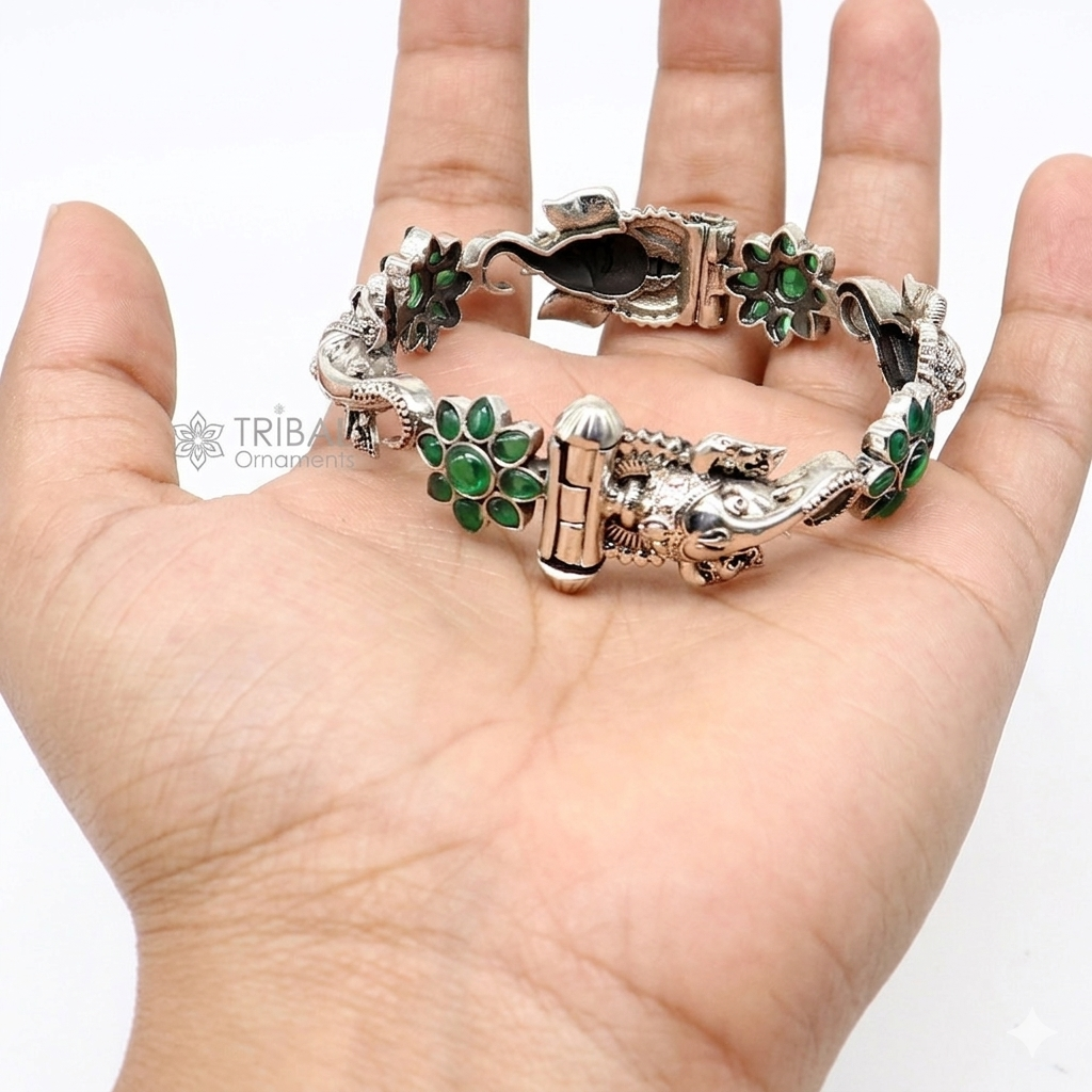 Sterling silver Ganesha bangle bracelet with floral design and green stone accents, traditional ethnic jewelry by TRIBAL ORNAMENTS.