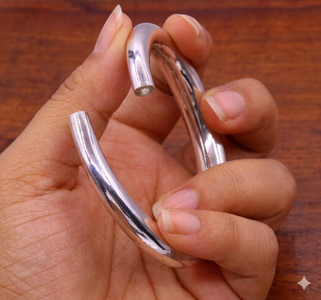 Sterling silver vintage open face bangle bracelet by TRIBAL ORNAMENTS featuring a plain handcrafted design, adjustable for unisex wear.