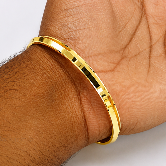 Gold polished 925 sterling silver Punjabi Sikkh Kada worn on wrist, showcasing traditional solid silver jewelry design.