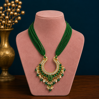 Gold polished sterling silver charm necklace with peacock pendant and hanging pearls, featuring intricate tribal ornament design.