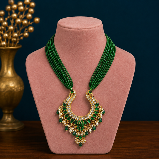 Gold polished sterling silver charm necklace with peacock pendant and hanging pearls, featuring intricate tribal ornament design.