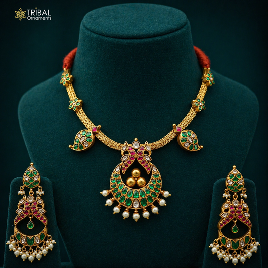 Sterling silver peacock charm necklace with gold polish, floral accents, and pearls, crafted by TRIBAL ORNAMENTS.