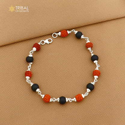 Unisex 925 sterling silver bracelet with black karungali beads and Rudraksha beads, featuring intricate tribal ornament design.