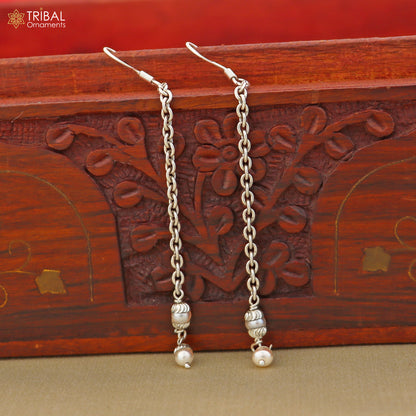 925 sterling silver pearl drop dangle earrings with silver hooks, featuring elegant white pearls on a jewelry display.