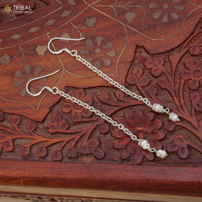 Sterling silver pearl drop earrings by Tribal Ornaments featuring elegant dangle design with lustrous pearls.