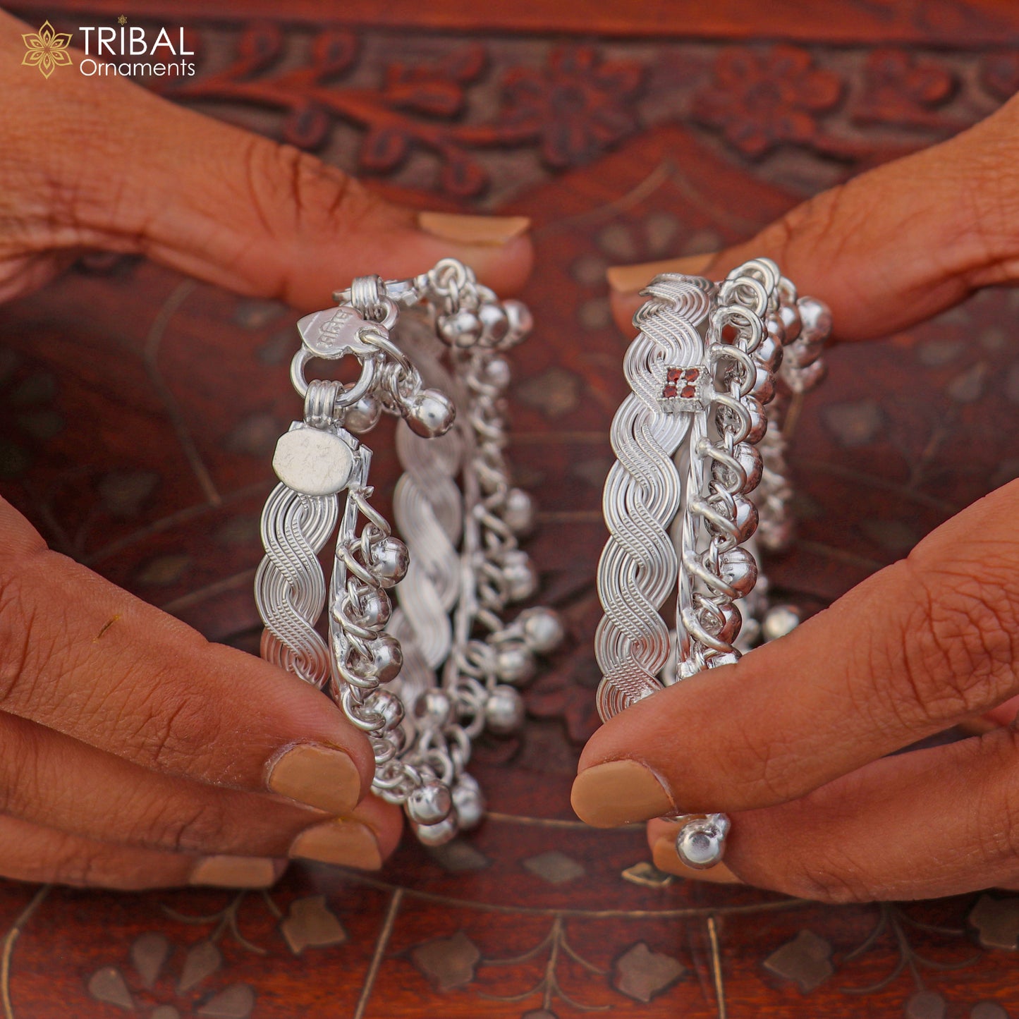 Sterling silver baby anklet by TRIBAL ORNAMENTS featuring personalized design and jingling charms on a delicate ankle bracelet.