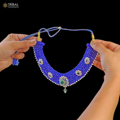 Silver blue Indian traditional choker necklace set with intricate cultural design from TRIBAL ORNAMENTS, shown on a display.