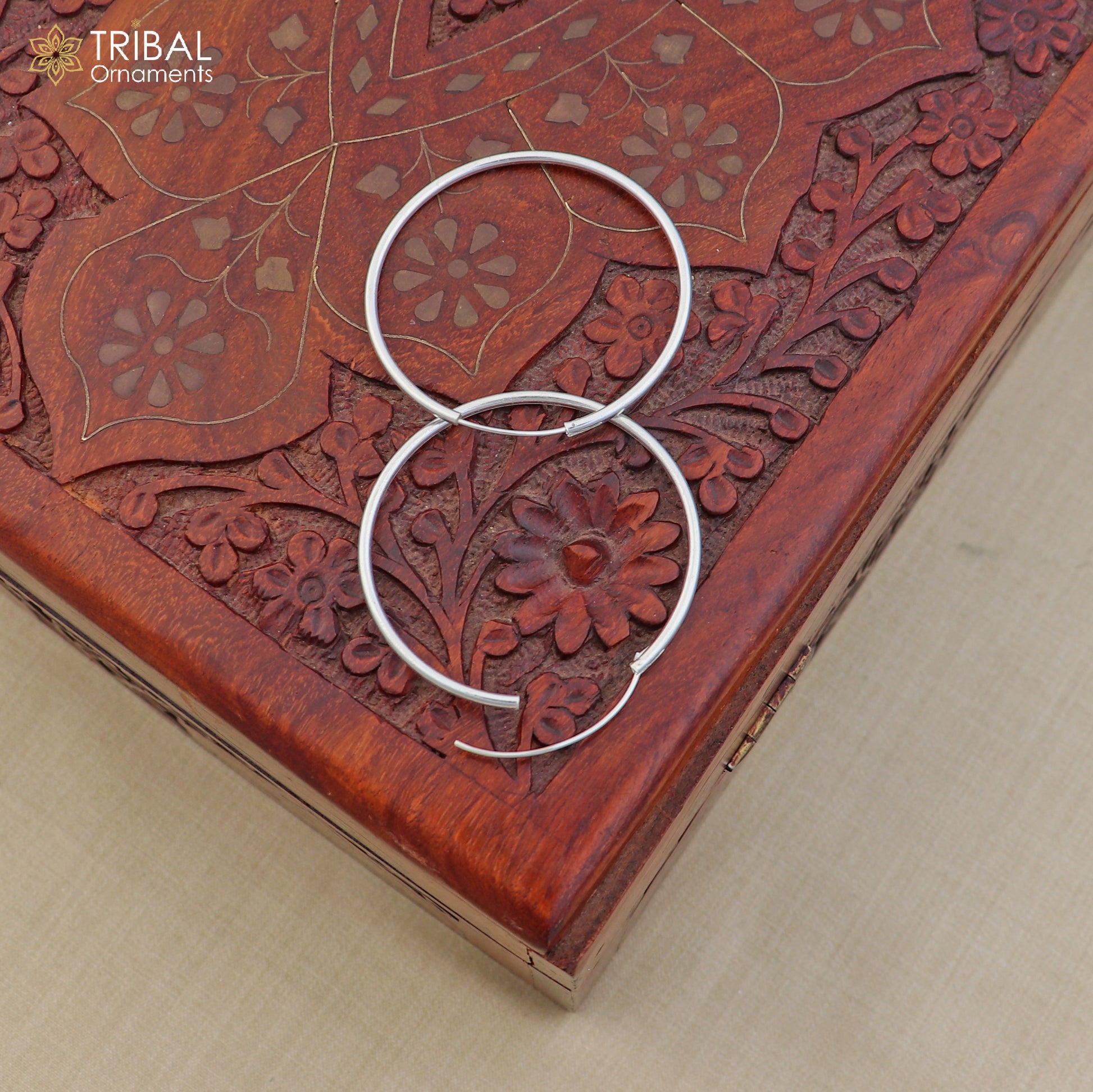 Elegant 925 sterling silver round hoop earrings from TRIBAL ORNAMENTS, showcasing smooth polished surface and classic hoop design.