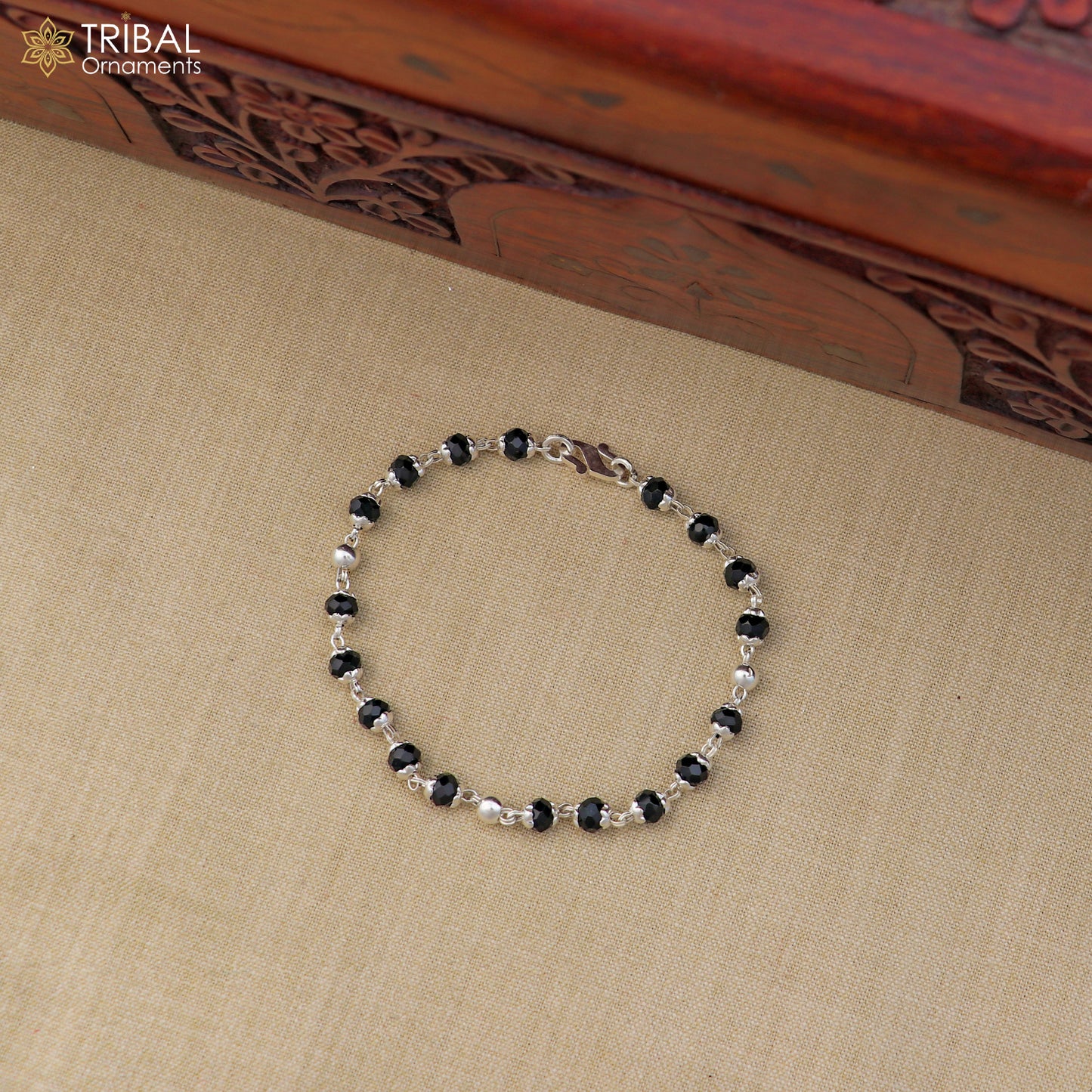 Unisex 6.5-inch sterling silver bracelet with black beads and Nazariya design from TRIBAL ORNAMENTS, jewelry accessory.