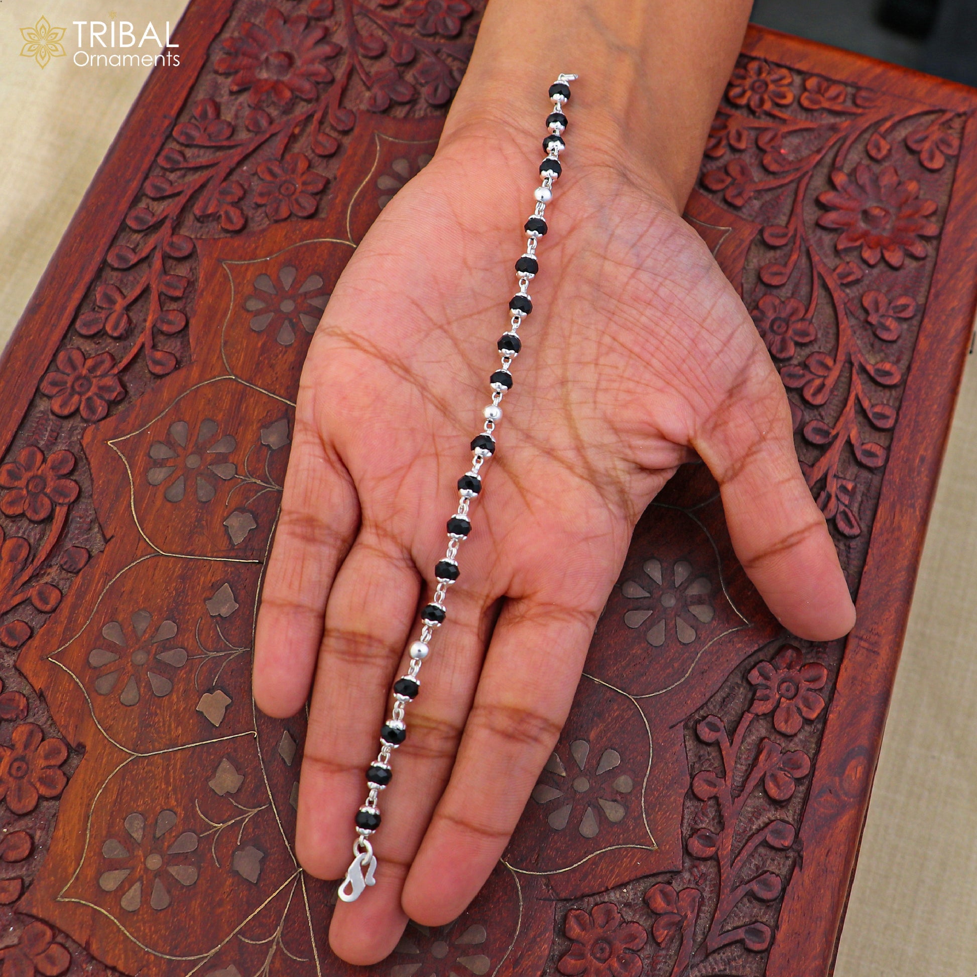 Sterling silver and black bead unisex nazariya bracelet with 6.5-inch length, featuring tribal ornament design.