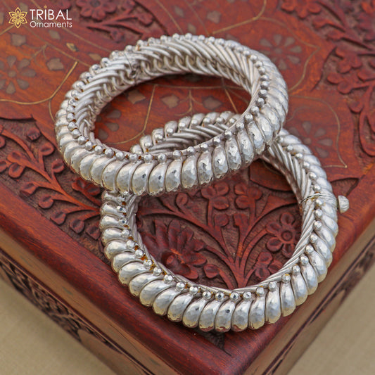 Sterling silver vintage spiral sutli design bangle by TRIBAL ORNAMENTS, showcasing intricate handcrafted jewelry with a unique pattern.
