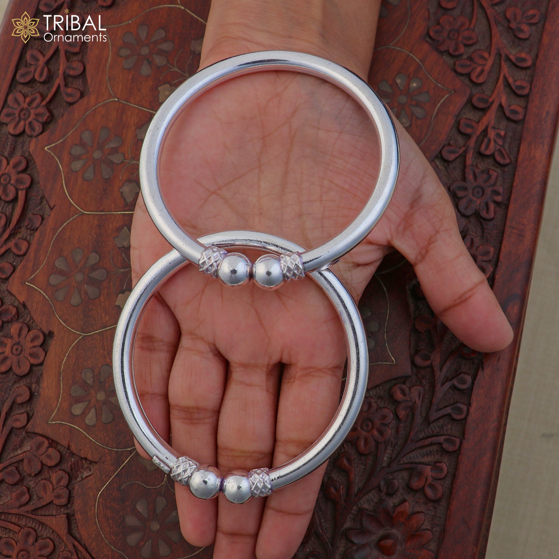 Sterling silver tribal bangle with stylish ball design, customizable jewelry by TRIBAL ORNAMENTS, featuring intricate tribal patterns.