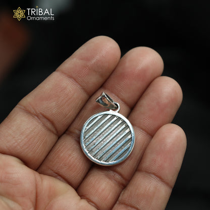 Unisex Orbit Code silver pendant made of 925 sterling silver with intricate tribal design, hanging from a silver chain.
