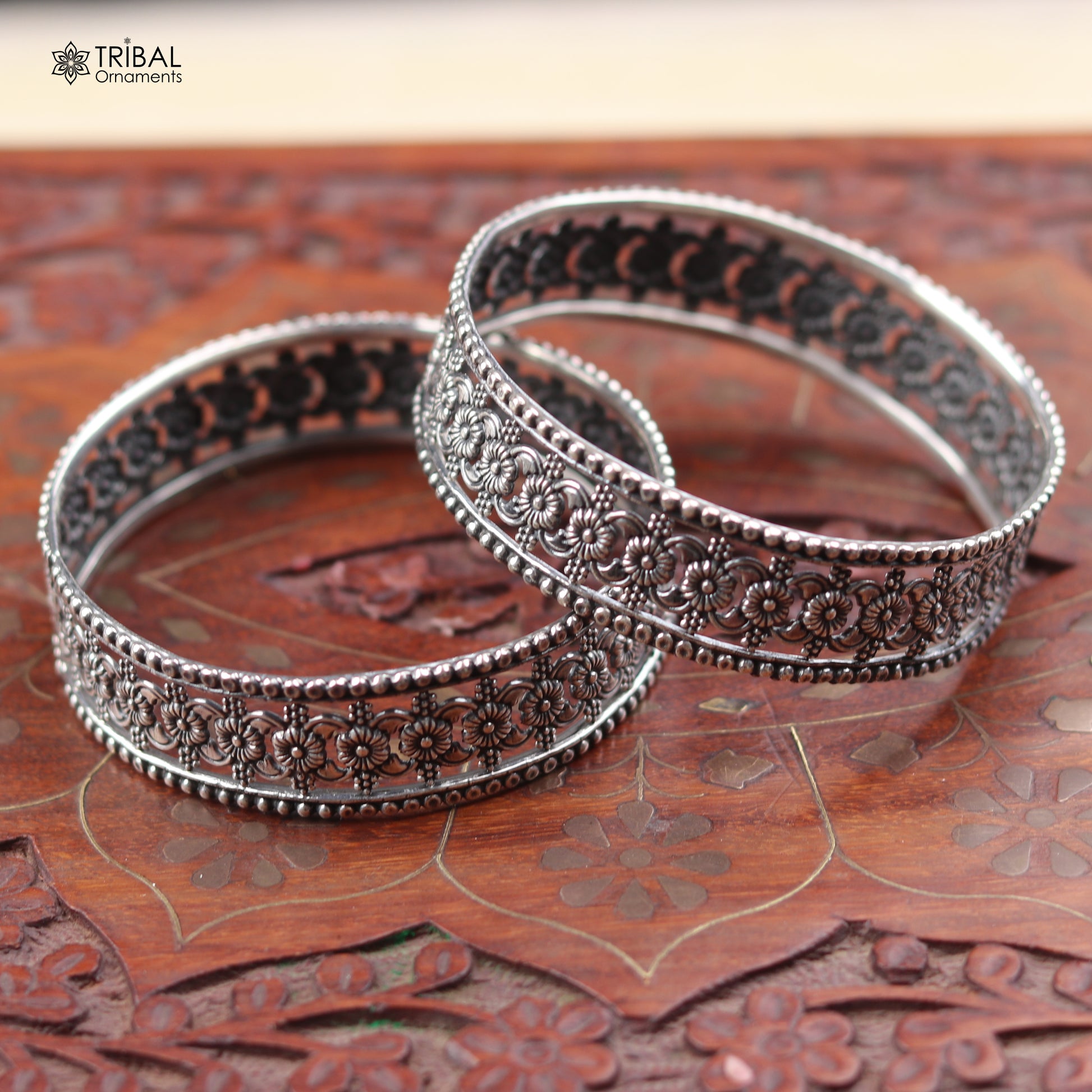 Sterling silver floral design bangle kada from TRIBAL ORNAMENTS, showcasing intricate ethnic jewelry craftsmanship.