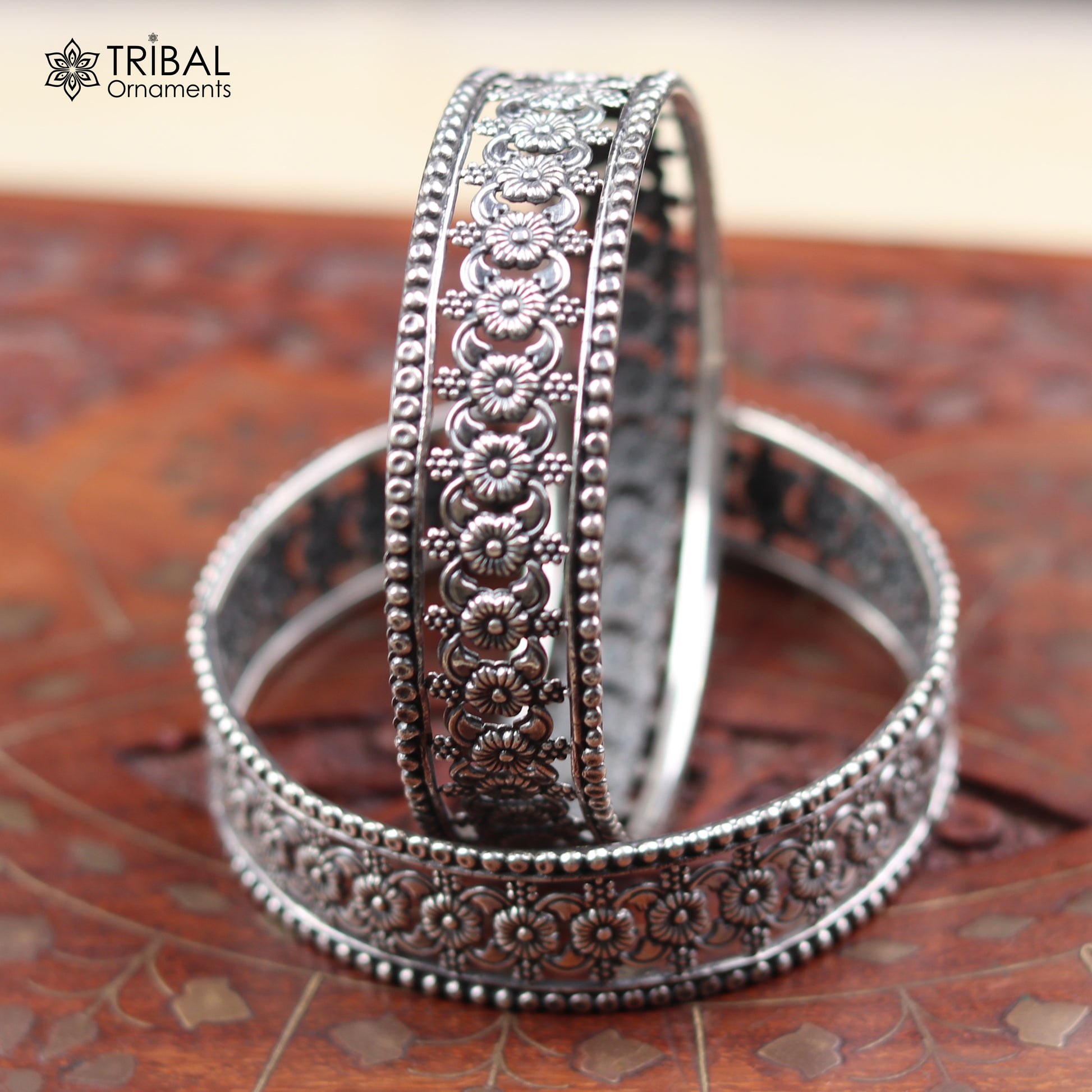 Sterling silver floral design bangle bracelet from TRIBAL ORNAMENTS, showcasing intricate ethnic jewelry craftsmanship.