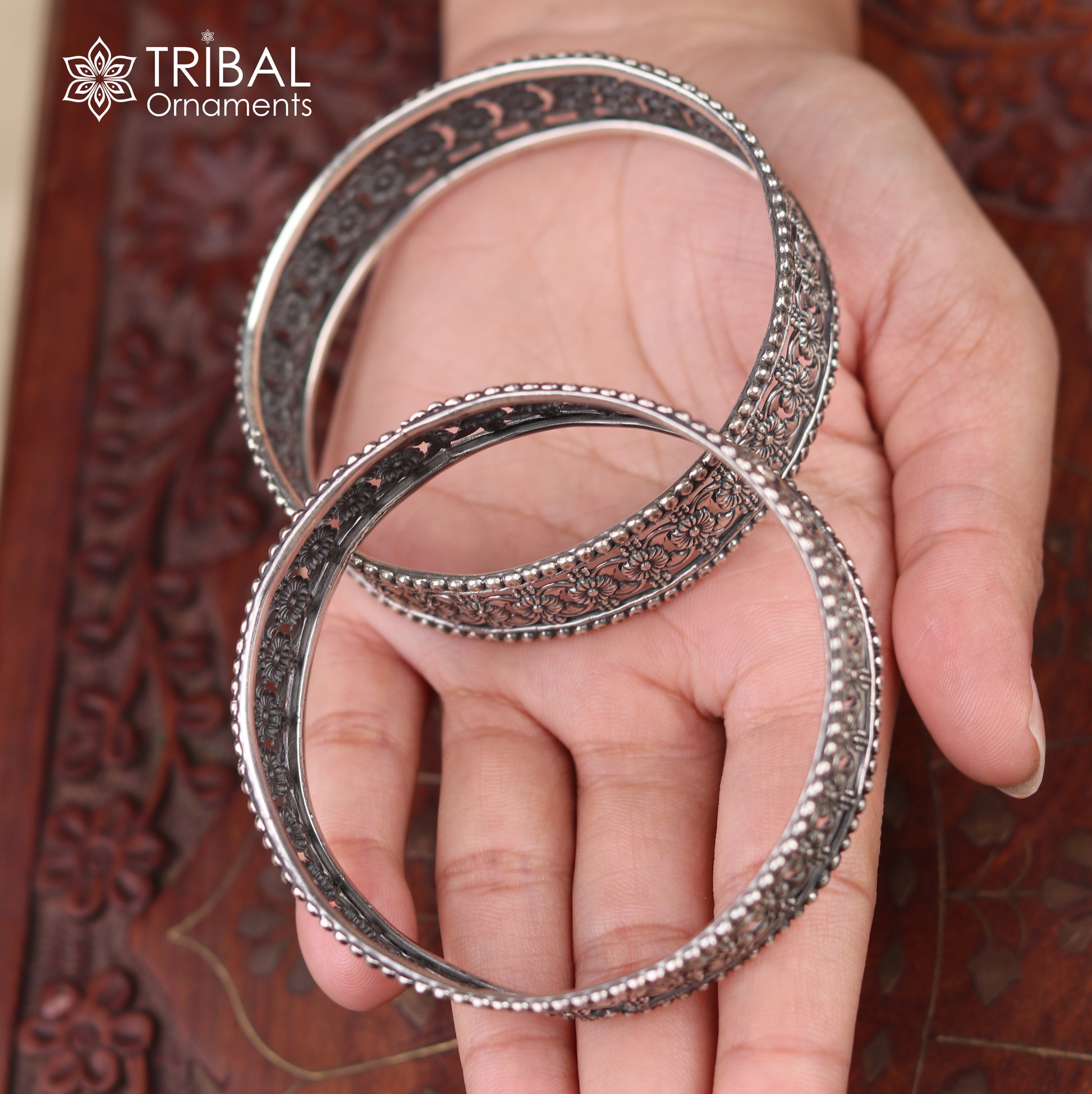 Sterling silver floral design bangle kada from TRIBAL ORNAMENTS, showcasing intricate ethnic jewelry craftsmanship.