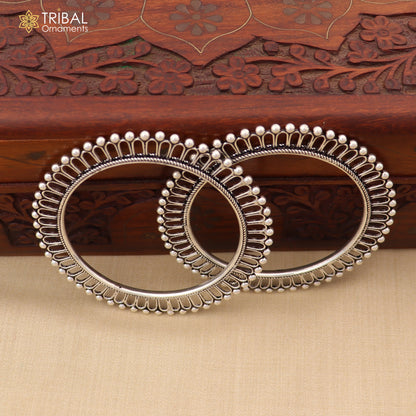 Sterling silver sun-inspired bangle bracelet with ethnic design from TRIBAL ORNAMENTS, showcasing intricate sun motif and polished finish.