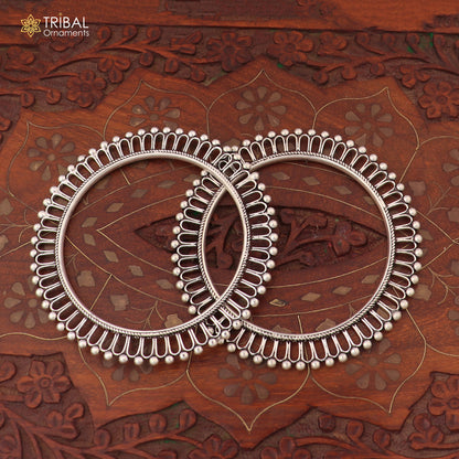 Sterling silver sun-inspired design bangle from TRIBAL ORNAMENTS, showcasing ethnic jewelry with intricate sun motif details.