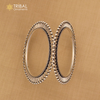Sterling silver sun-inspired bangle bracelet with ethnic design by TRIBAL ORNAMENTS, showcasing detailed sun motifs and intricate craftsmanship.