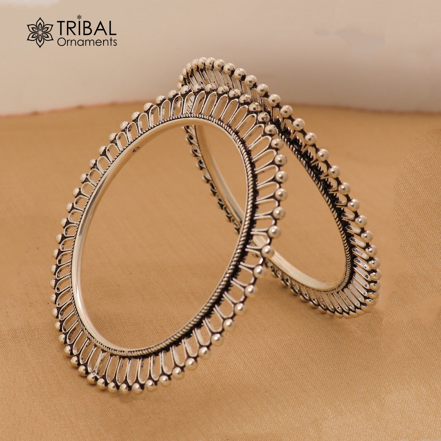 Sterling silver sun-inspired bangle bracelet with ethnic design from TRIBAL ORNAMENTS, showcasing intricate craftsmanship.