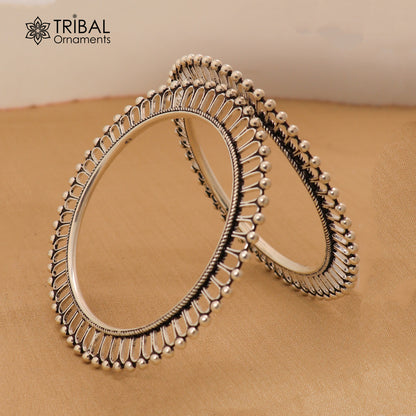 Sterling silver sun-inspired bangle bracelet with ethnic design from TRIBAL ORNAMENTS, showcasing intricate craftsmanship.