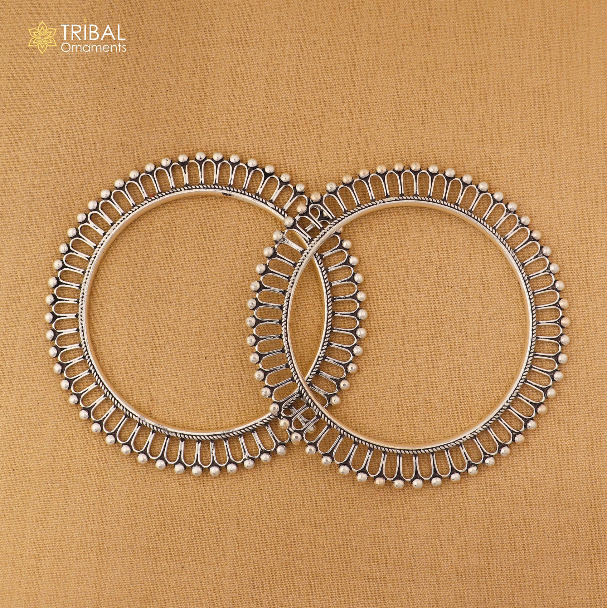 Sterling silver sun-inspired design bangle kada from TRIBAL ORNAMENTS, featuring ethnic jewelry style with intricate details.