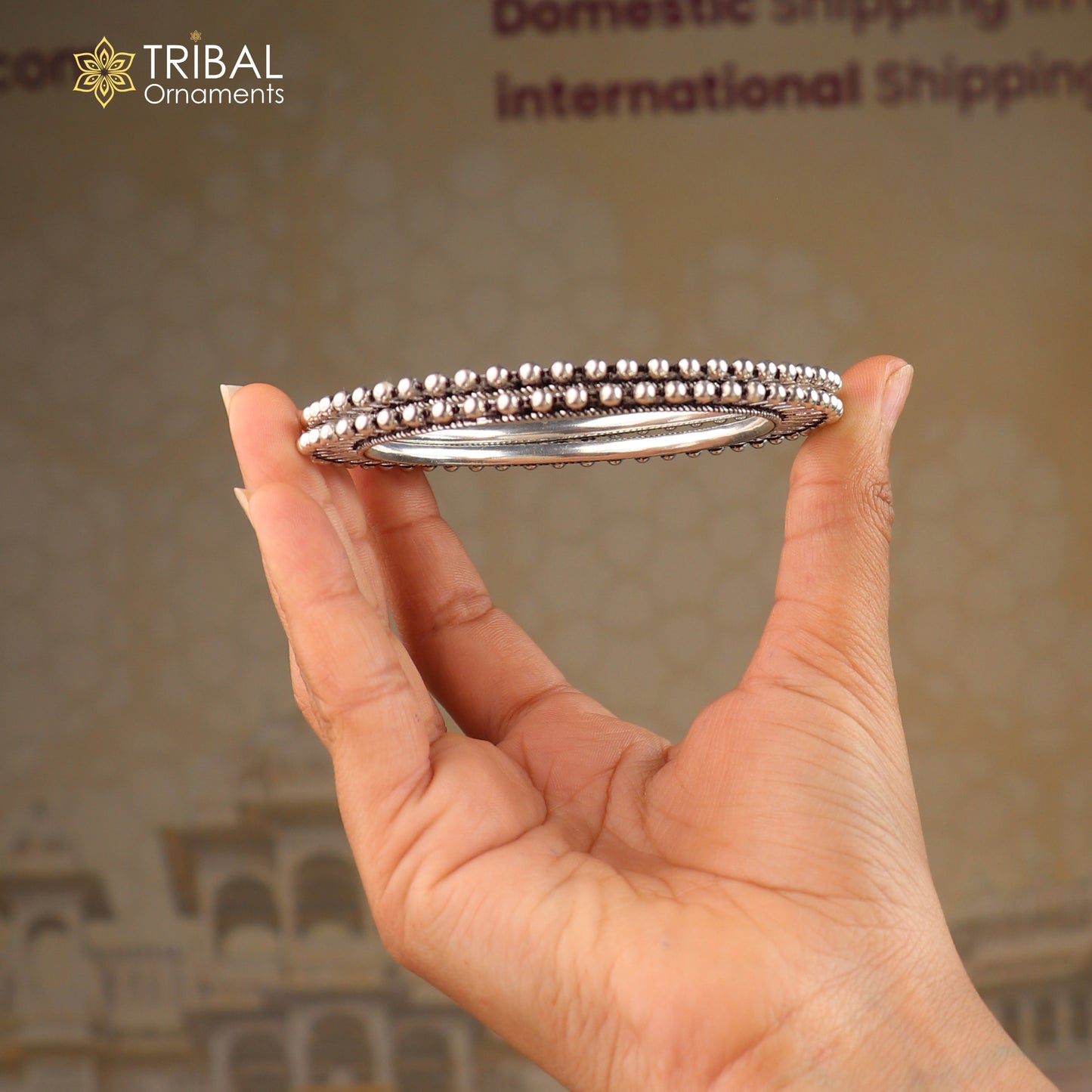 Sterling silver sun-inspired design bangle from TRIBAL ORNAMENTS, ethnic jewelry bracelet with intricate sun motif.