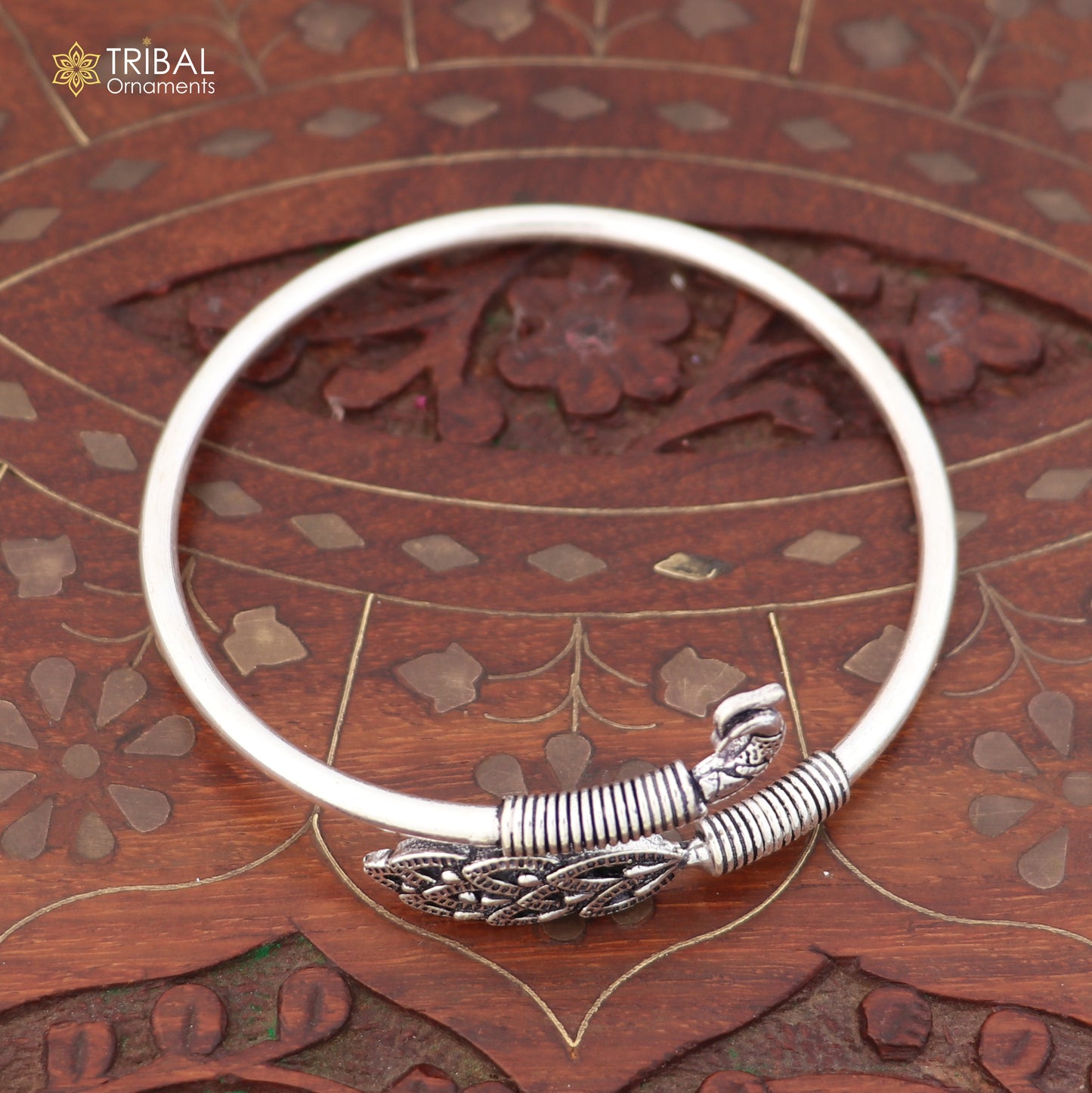 Sterling silver Peacock style bangle bracelet by TRIBAL ORNAMENTS, featuring an easy slip-on design and intricate jewelry details.
