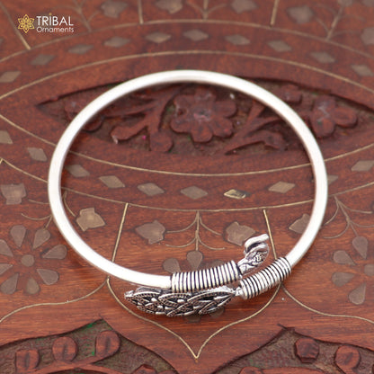 Sterling silver Peacock style bangle bracelet by TRIBAL ORNAMENTS, featuring an easy slip-on design and intricate jewelry details.
