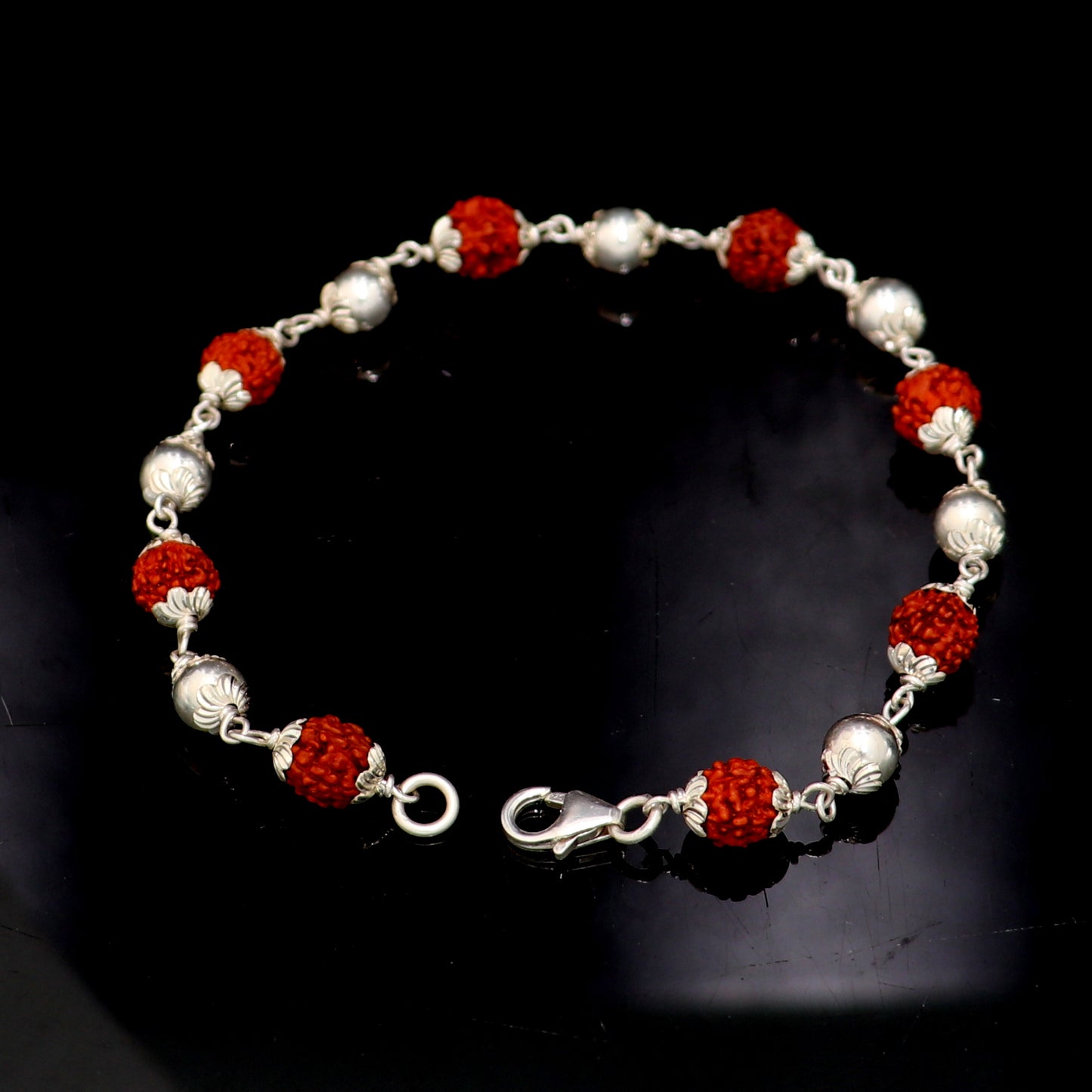 Unisex 925 sterling silver and rudraksha beads bracelet with intricate design, crafted by TRIBAL ORNAMENTS for spiritual jewelry.