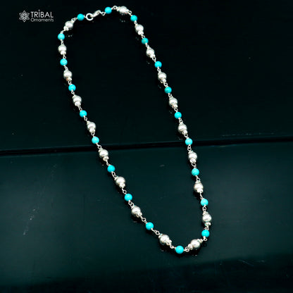 Sterling silver and turquoise-colored round beaded necklace with tribal design, featuring multiple bead strands and intricate details.