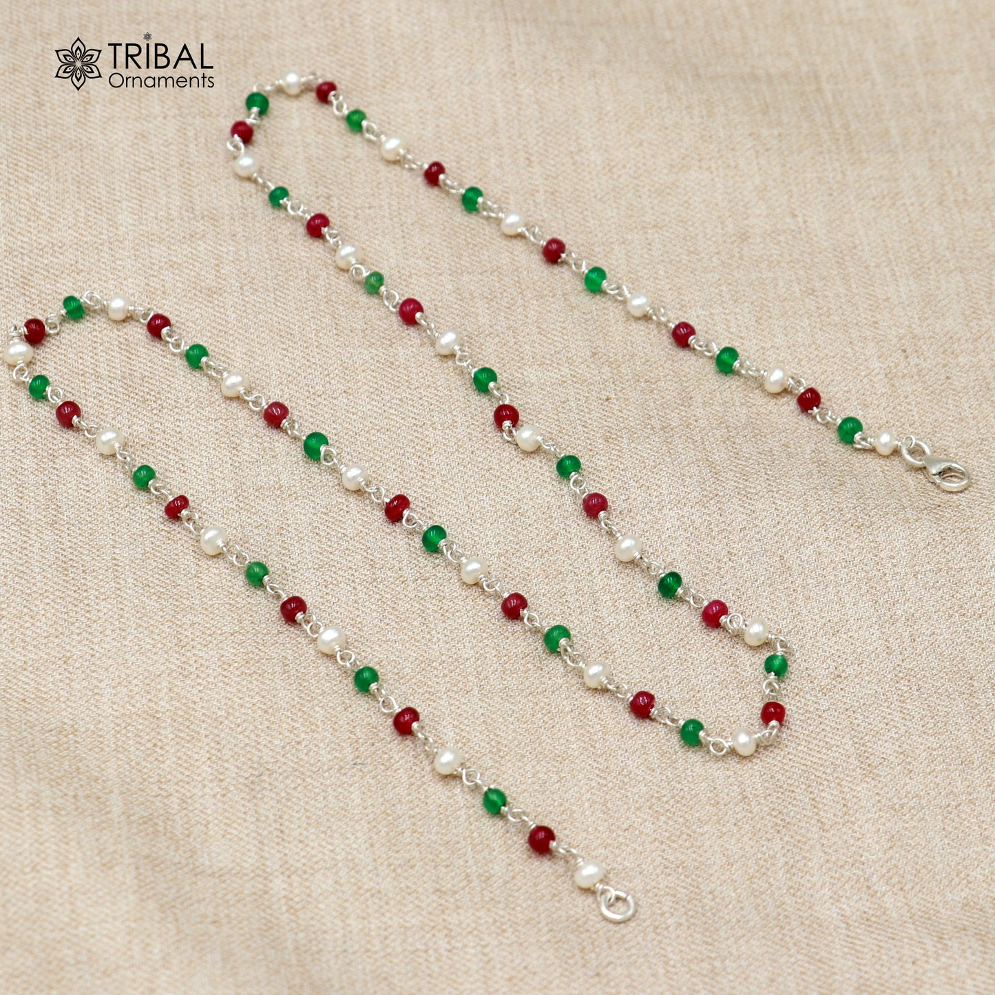 Sterling silver beaded necklace with pearls and multicolor round stones, featuring intricate tribal ornament designs.