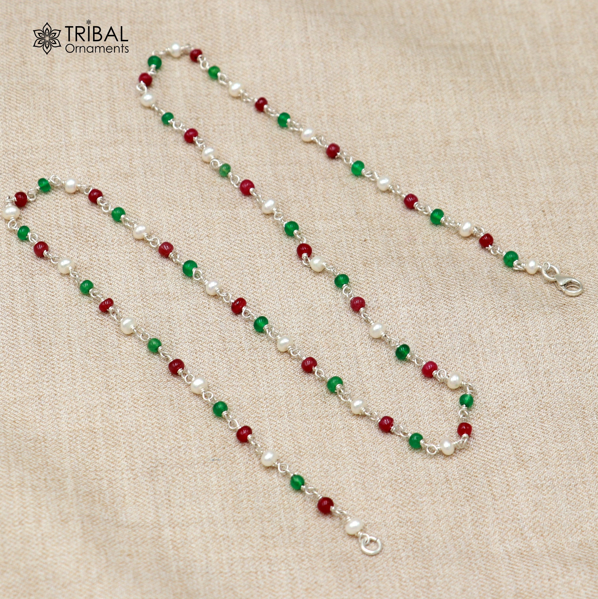 Sterling silver beaded necklace with pearls and multicolor round stones, featuring intricate tribal ornament designs.