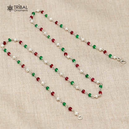 Sterling silver beaded necklace with pearls and multicolor round stones, featuring intricate tribal ornament designs.