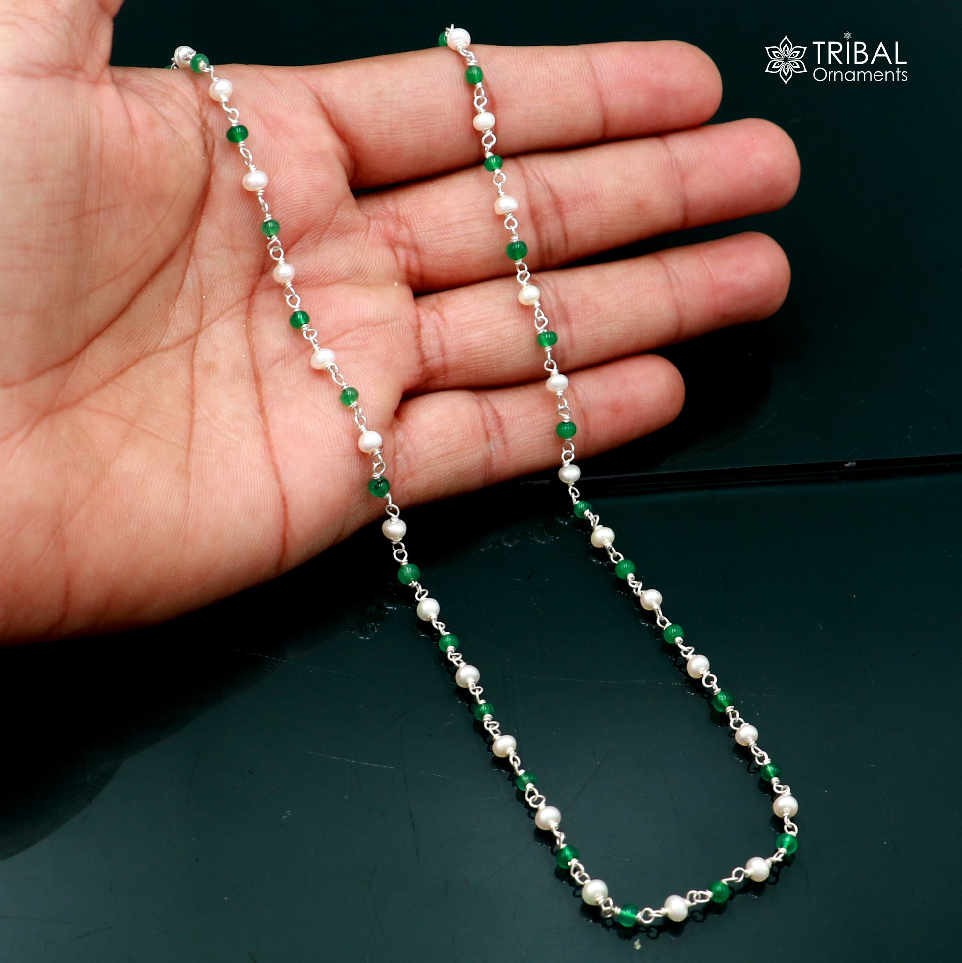 Sterling silver beaded chain with pearls and green stones, jewelry piece by TRIBAL ORNAMENTS, featuring intricate beadwork and vibrant accents.