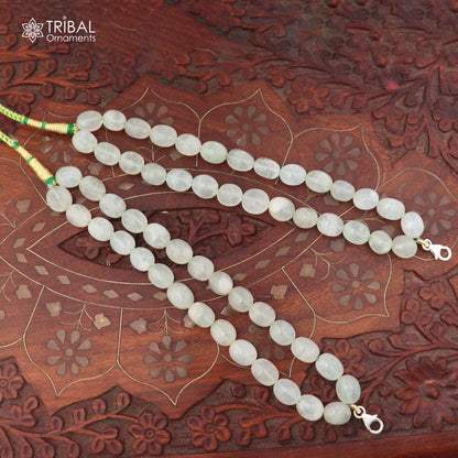 Sterling silver lock and jade bead necklace with tribal design, featuring a pendant in a traditional jewelry style.