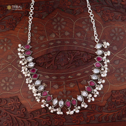 Sterling silver ethnic jewelry set with ruby red and white cut stones, including necklace and earrings from TRIBAL ORNAMENTS.