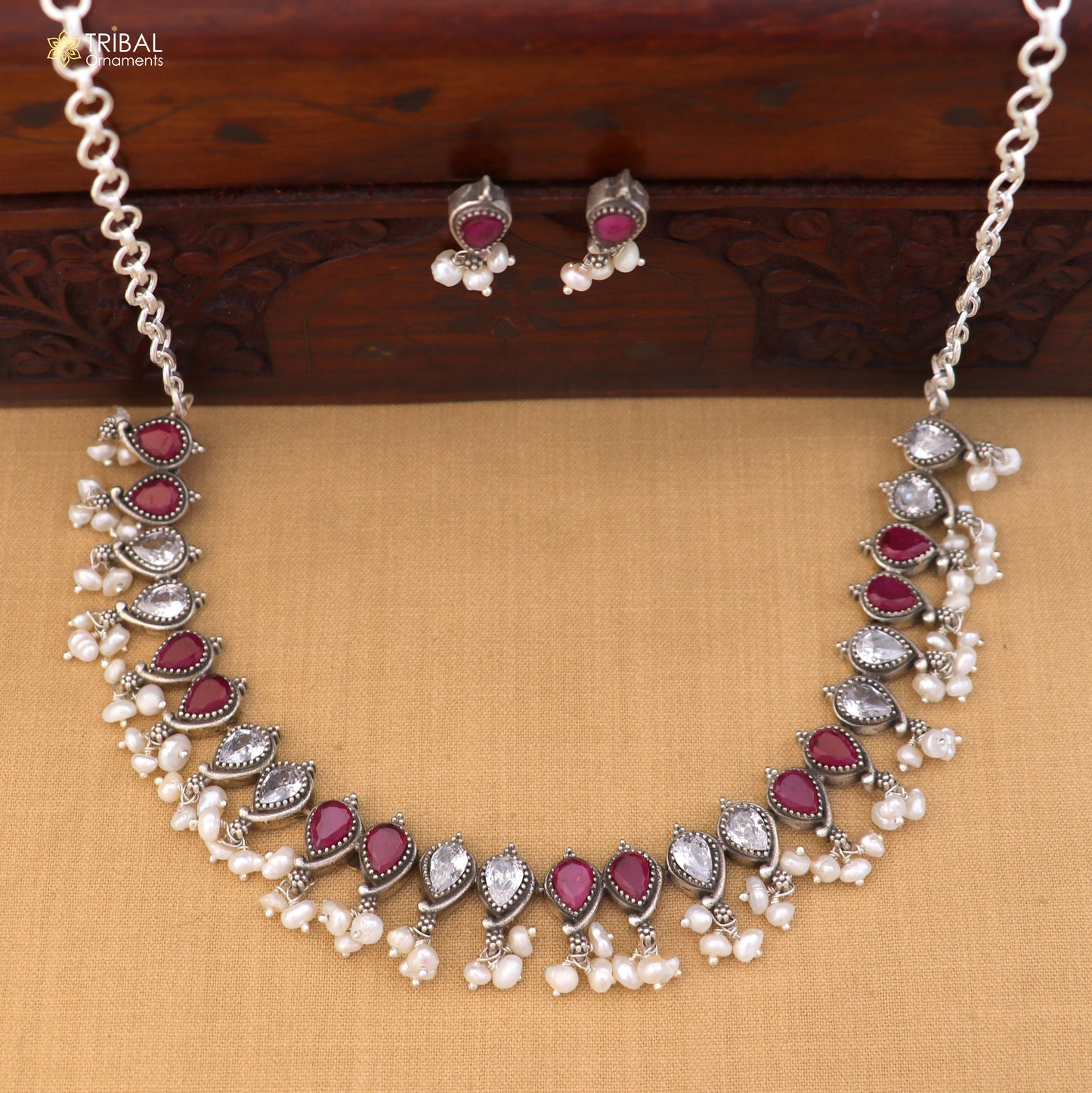 Sterling silver ethnic jewelry set with ruby red and white cut stones, including necklace and earrings by TRIBAL ORNAMENTS