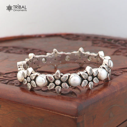 Sterling silver floral stone bangle bracelet with ethnic design, featuring intricate flower motifs and colorful gemstones.