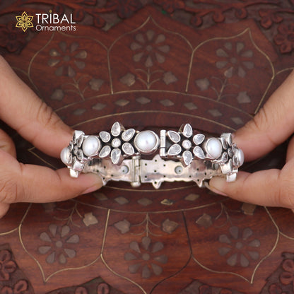 Sterling silver floral-style stone bangle bracelet with ethnic design from TRIBAL ORNAMENTS, showcasing intricate floral patterns and vibrant stones.